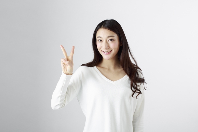 指で2を示す女性